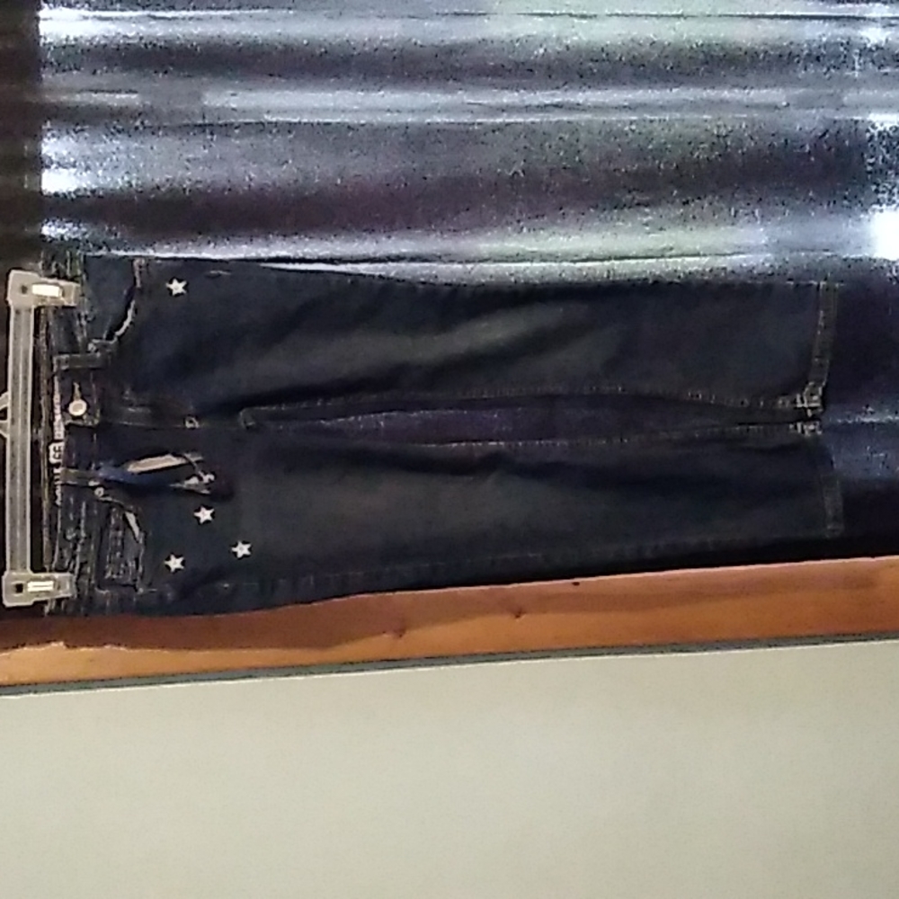 Blue jean pants with stars and words the back